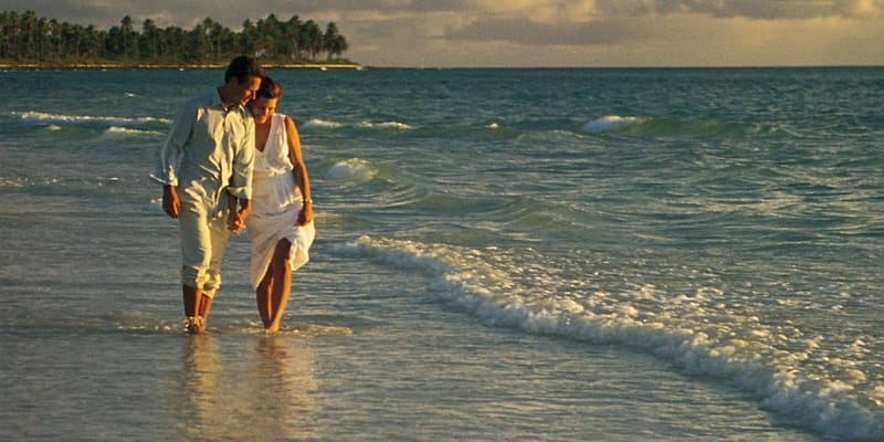 Couple walking on the beach in The Bahamas