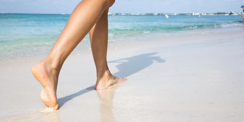 Woman walking on a beautiful beach in the Cayman Islands