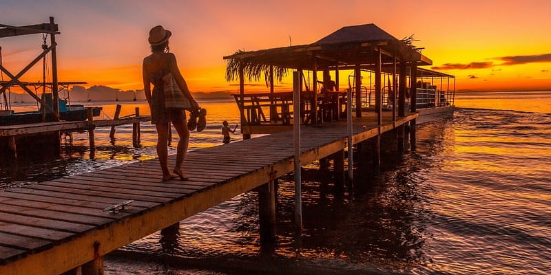 Woman on a pier in Roatan at sunset